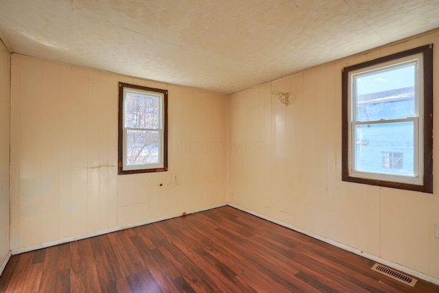 unfurnished room featuring dark hardwood / wood-style flooring