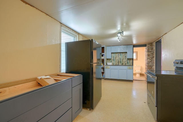 kitchen featuring black fridge and electric stove