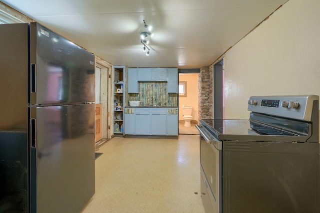 kitchen with black fridge and stainless steel range with electric cooktop