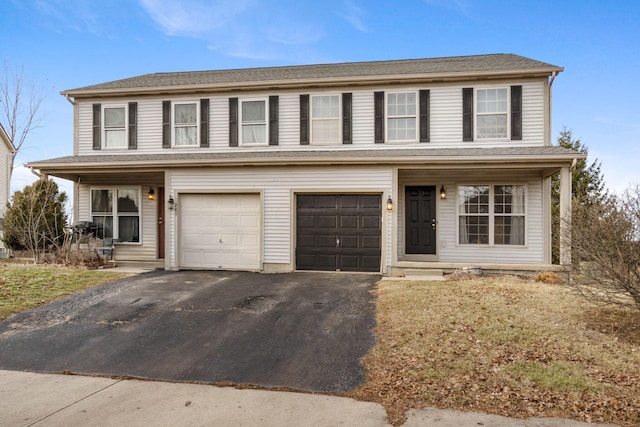 view of front facade with a garage, a porch, and aphalt driveway