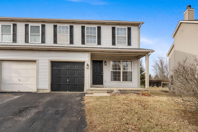 view of front of home featuring covered porch, driveway, and an attached garage