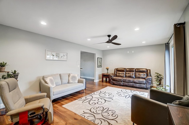 living room featuring ceiling fan and hardwood / wood-style floors