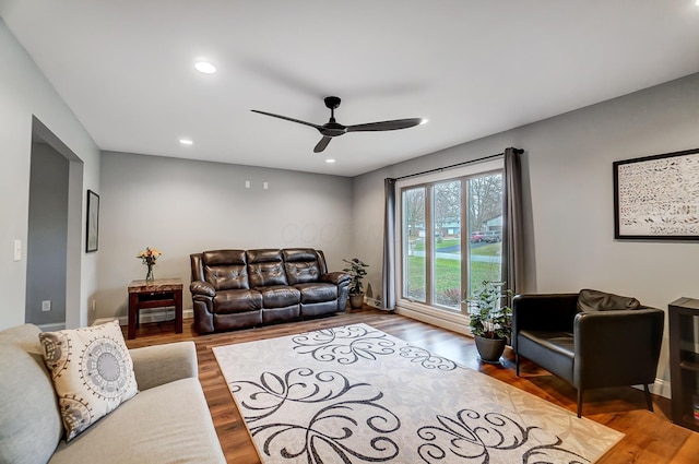 living room with hardwood / wood-style flooring and ceiling fan