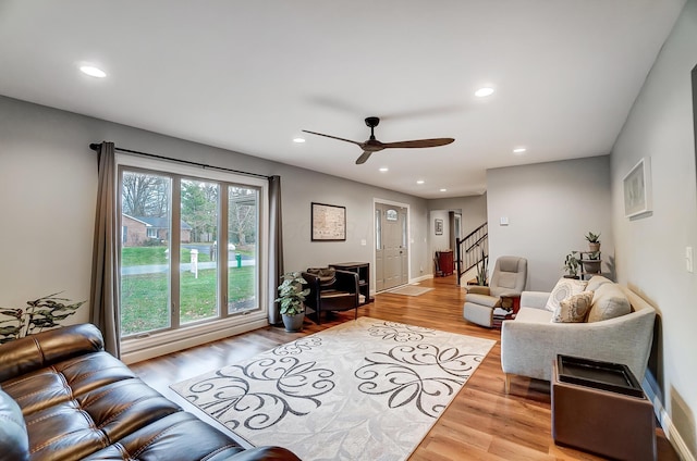 living room featuring ceiling fan and light wood-type flooring