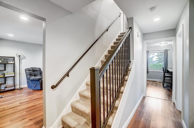 stairway with hardwood / wood-style floors