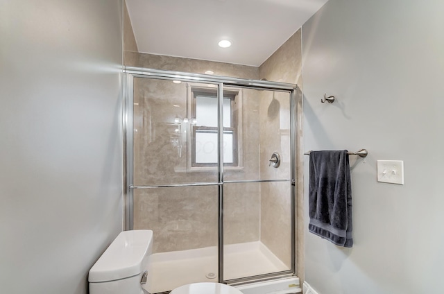 bathroom with toilet and walk in shower