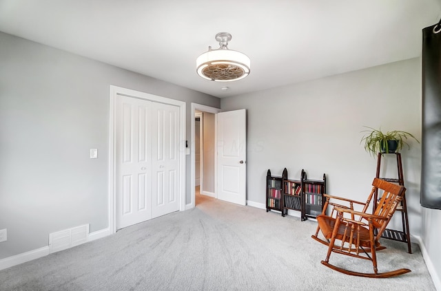 living area featuring carpet