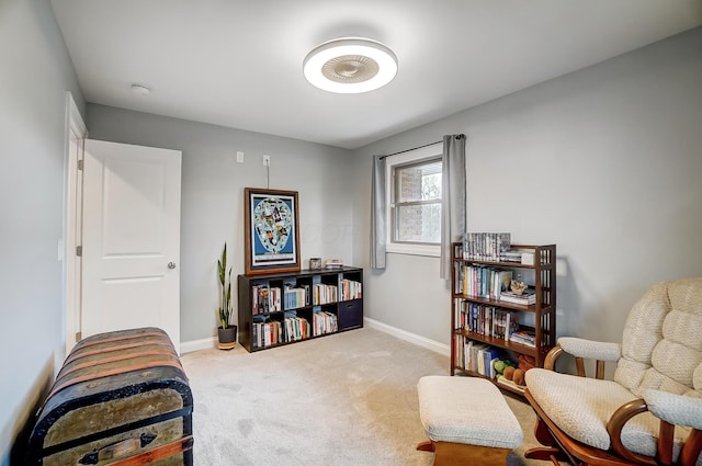 sitting room featuring light colored carpet