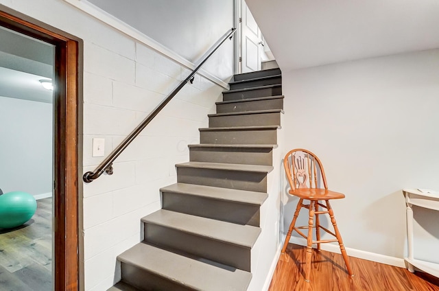 stairway with hardwood / wood-style flooring