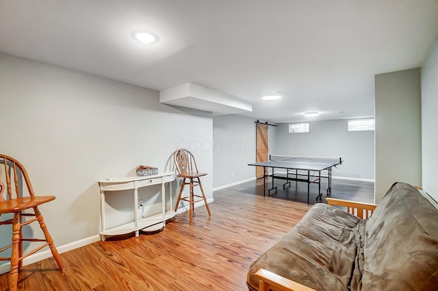 interior space with a barn door and hardwood / wood-style floors