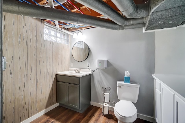 bathroom with vanity, toilet, and hardwood / wood-style floors