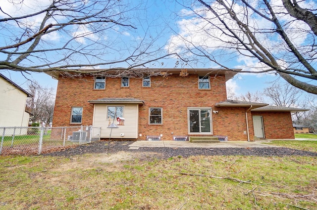 back of house featuring a yard and central air condition unit