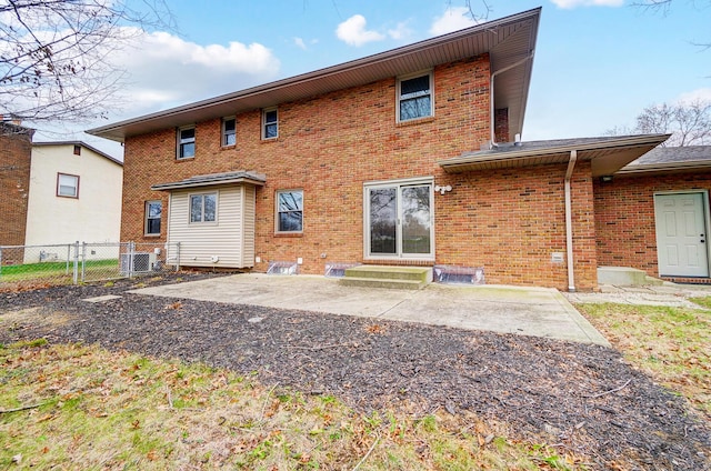 rear view of house with central air condition unit and a patio area