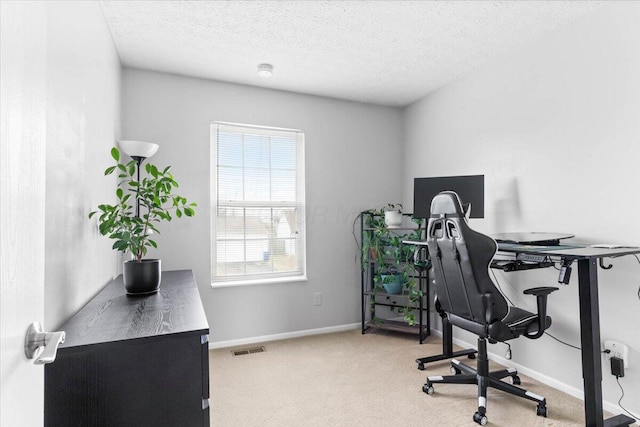 home office with baseboards, visible vents, a textured ceiling, and carpet