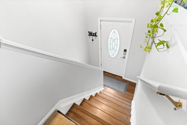 stairway featuring baseboards and wood finished floors