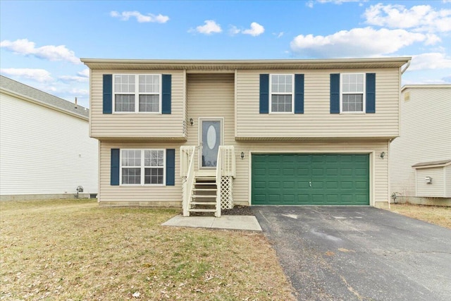 bi-level home featuring driveway, an attached garage, and a front yard