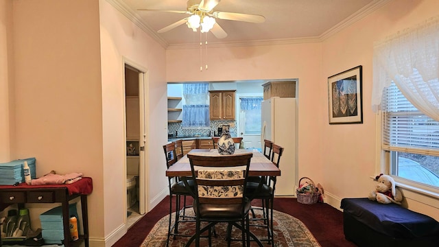 dining area featuring crown molding and ceiling fan