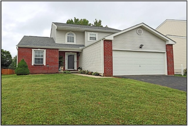 view of property featuring a garage and a front yard