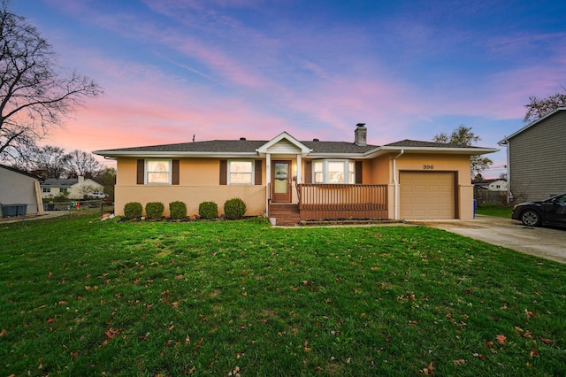 ranch-style home with a yard and a garage