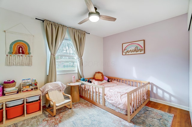 bedroom with hardwood / wood-style floors and ceiling fan