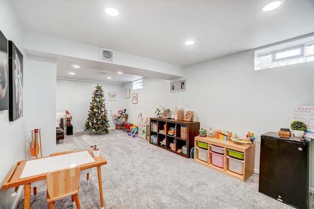 rec room with light colored carpet