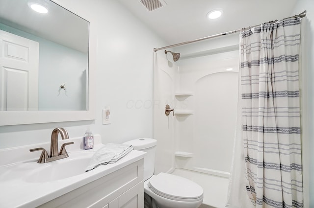 bathroom featuring toilet, vanity, and a shower with shower curtain