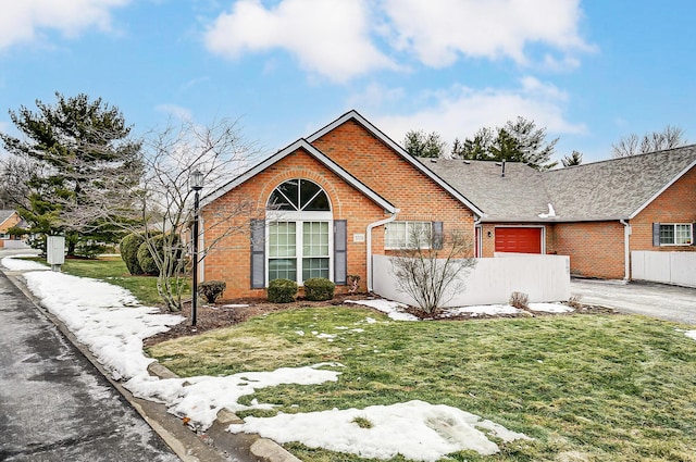 view of front of home featuring a garage and a front yard