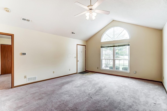 empty room with light carpet, high vaulted ceiling, and ceiling fan