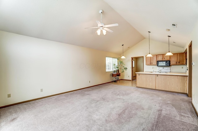 unfurnished living room with high vaulted ceiling, light colored carpet, and ceiling fan