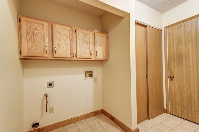 laundry area featuring light tile patterned floors, hookup for a washing machine, cabinets, a textured ceiling, and hookup for an electric dryer