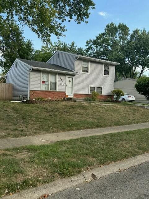 split level home featuring a front lawn