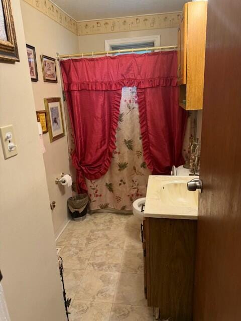 bathroom featuring walk in shower, vanity, and toilet