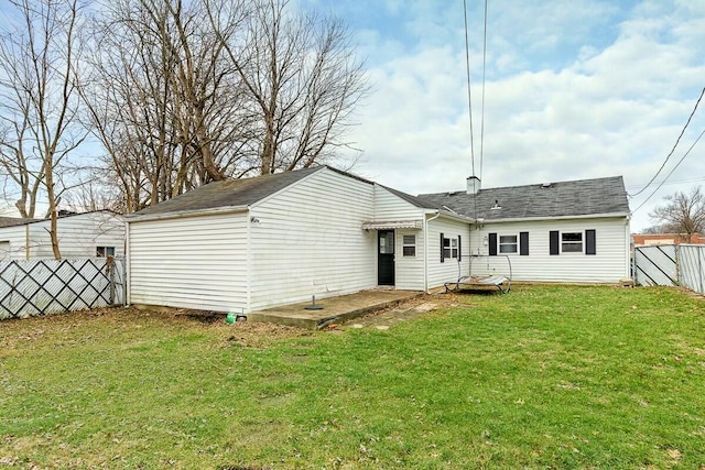 rear view of house with a lawn