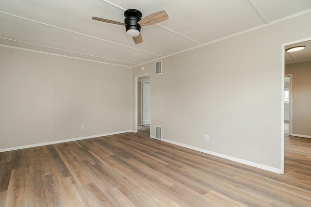 spare room featuring crown molding, ceiling fan, and light hardwood / wood-style flooring