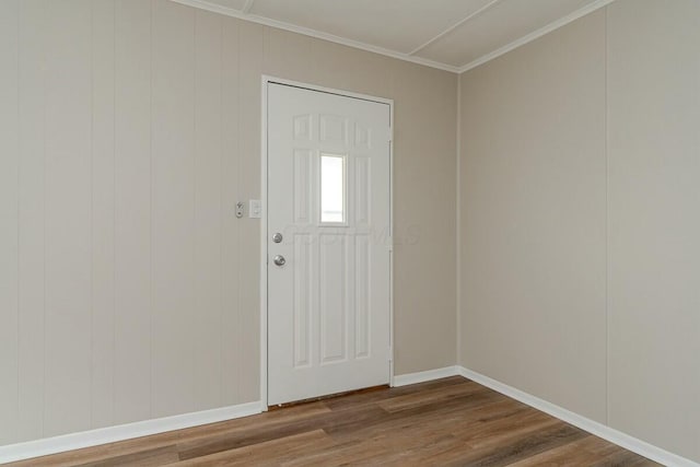 entrance foyer featuring crown molding and wood-type flooring