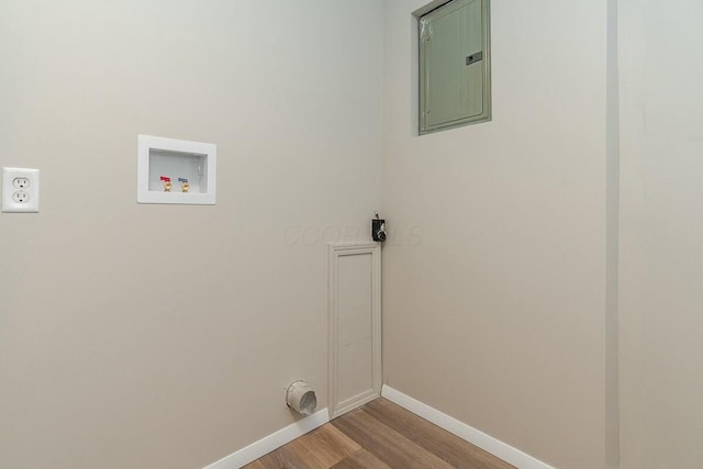 laundry area with hookup for a washing machine, electric panel, and light hardwood / wood-style floors