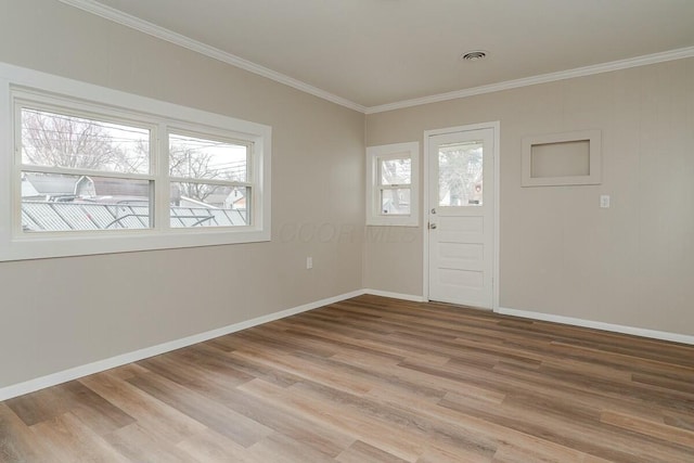 foyer featuring ornamental molding and light hardwood / wood-style flooring