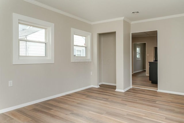 unfurnished room with ornamental molding and light hardwood / wood-style floors