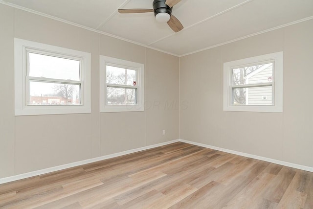 empty room featuring ceiling fan, ornamental molding, and light hardwood / wood-style flooring