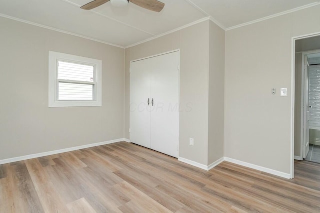 unfurnished bedroom featuring crown molding, a closet, ceiling fan, and light hardwood / wood-style flooring