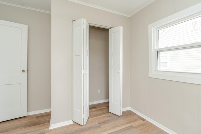 unfurnished bedroom with crown molding and light hardwood / wood-style floors