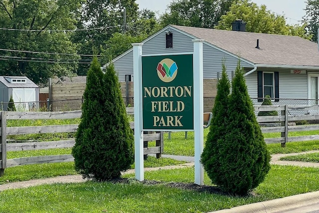 community / neighborhood sign featuring a yard