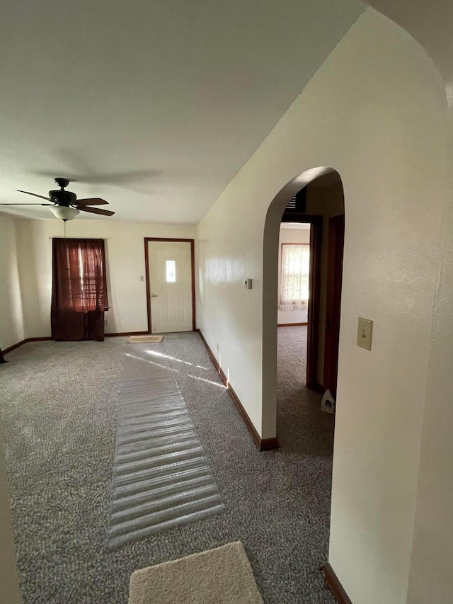 corridor with dark colored carpet and lofted ceiling