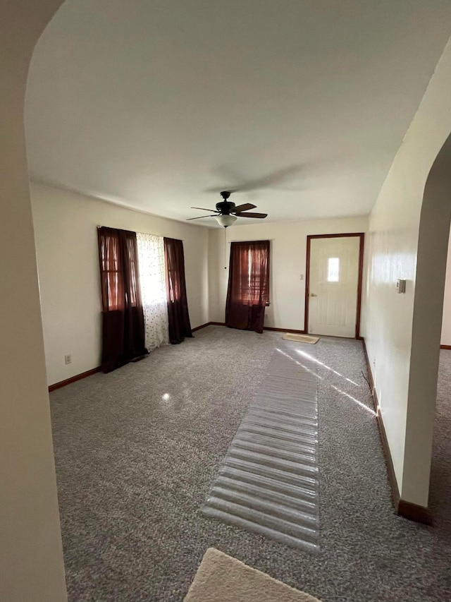 interior space featuring carpet and ceiling fan