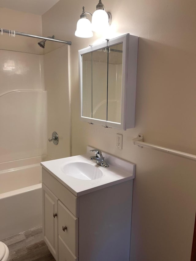 full bathroom featuring hardwood / wood-style flooring, vanity, toilet, and bathing tub / shower combination