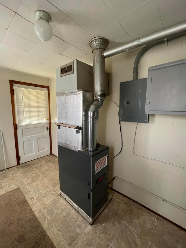 utility room with heating unit and electric panel