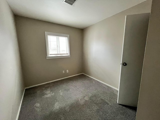 empty room featuring dark colored carpet