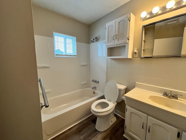 full bathroom featuring hardwood / wood-style flooring, tile walls, vanity, shower / bathtub combination, and toilet