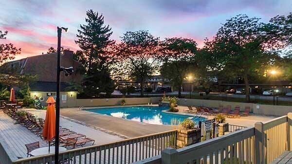 pool at dusk featuring a patio area