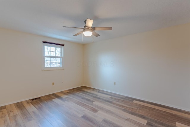 unfurnished room with light hardwood / wood-style flooring and ceiling fan